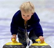 un bambino che gioca con le stones curling